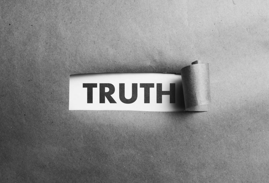Torn+paper+with+truth+word+behind+it%2C+black+and+white+photo