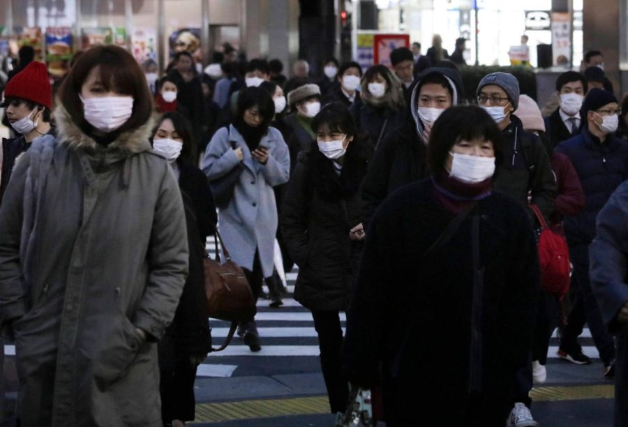 Pedestrians+in+Tokyo+wearing+protective+masks.Courtesy+of+New+York+Times