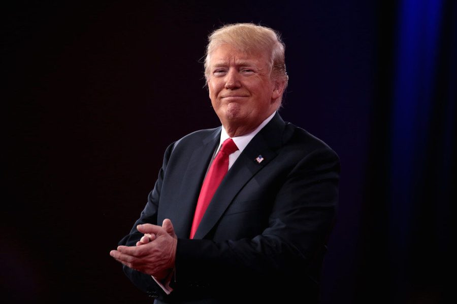 President Donald Trump claps at a past event.