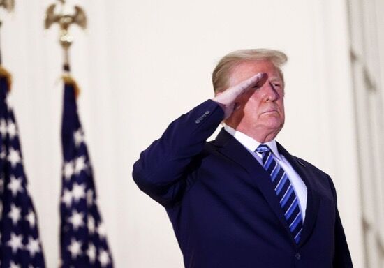 Trump saluting from the balcony of the White House after returning from Walter Reed.