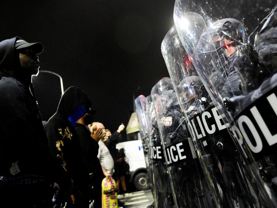 Demonstrators and riot police face off a day after the shooting.