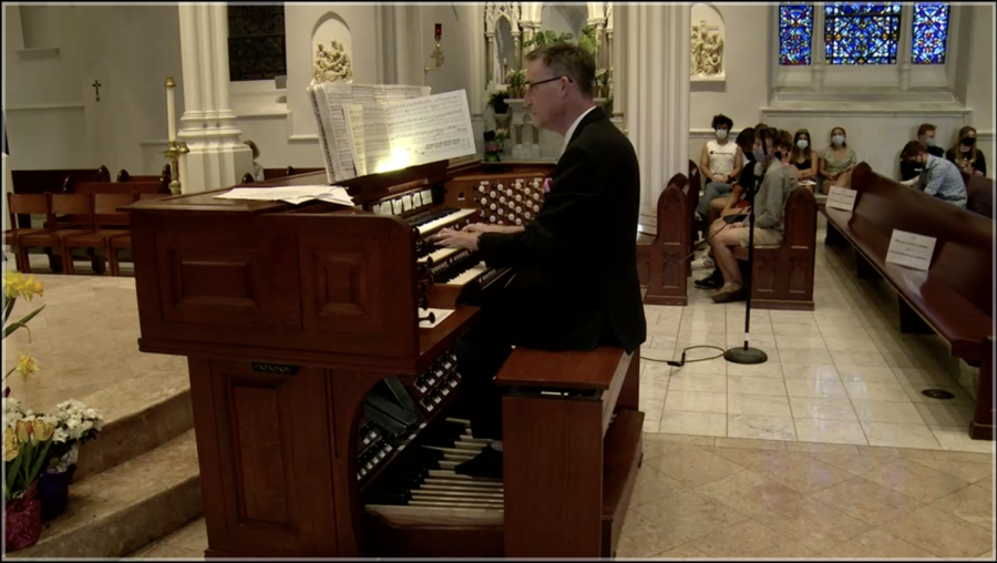 Dr. Christopher Daly performs in the church for an attentive crowd.