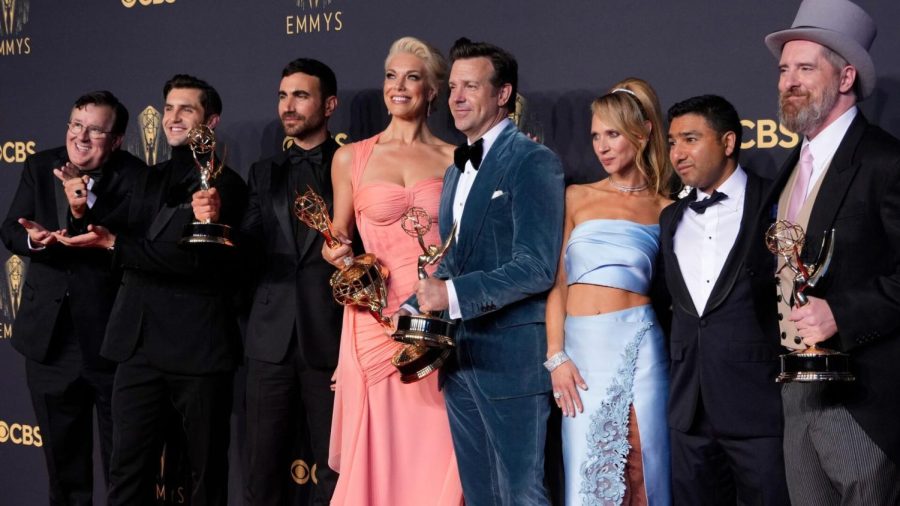 The cast and creative team of “Ted Lasso” pose with their Emmy Awards.