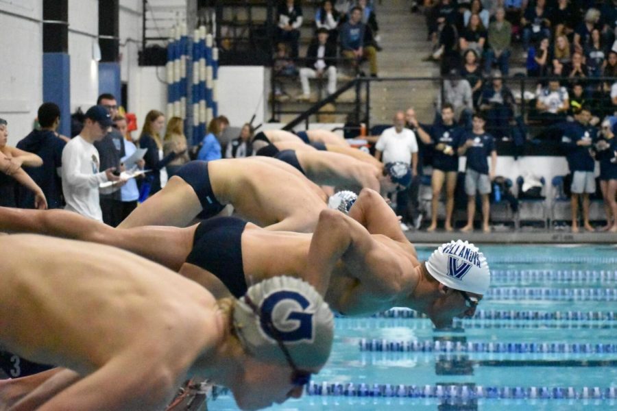 Junior+Ryan+Maher+dives+into+the+pool+to+start+a+race.