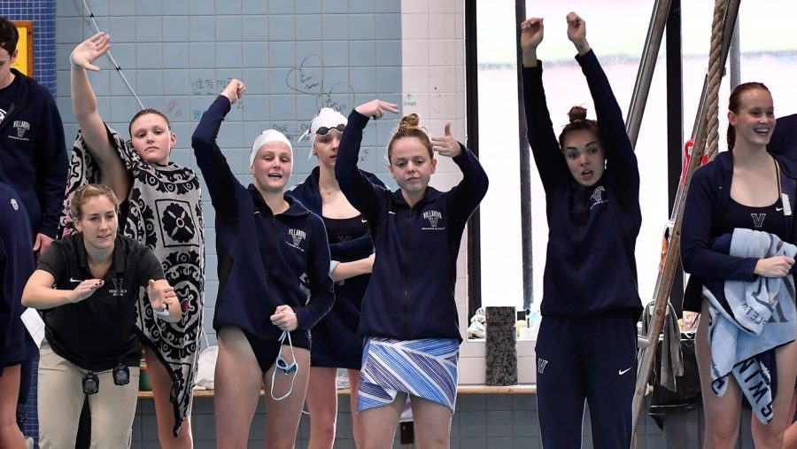 The womens swim and dive team celebrates during their weekend win. 