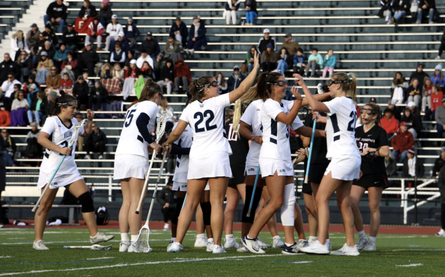 Womens lacrosse celebrates after scoring a goal this past weekend. 