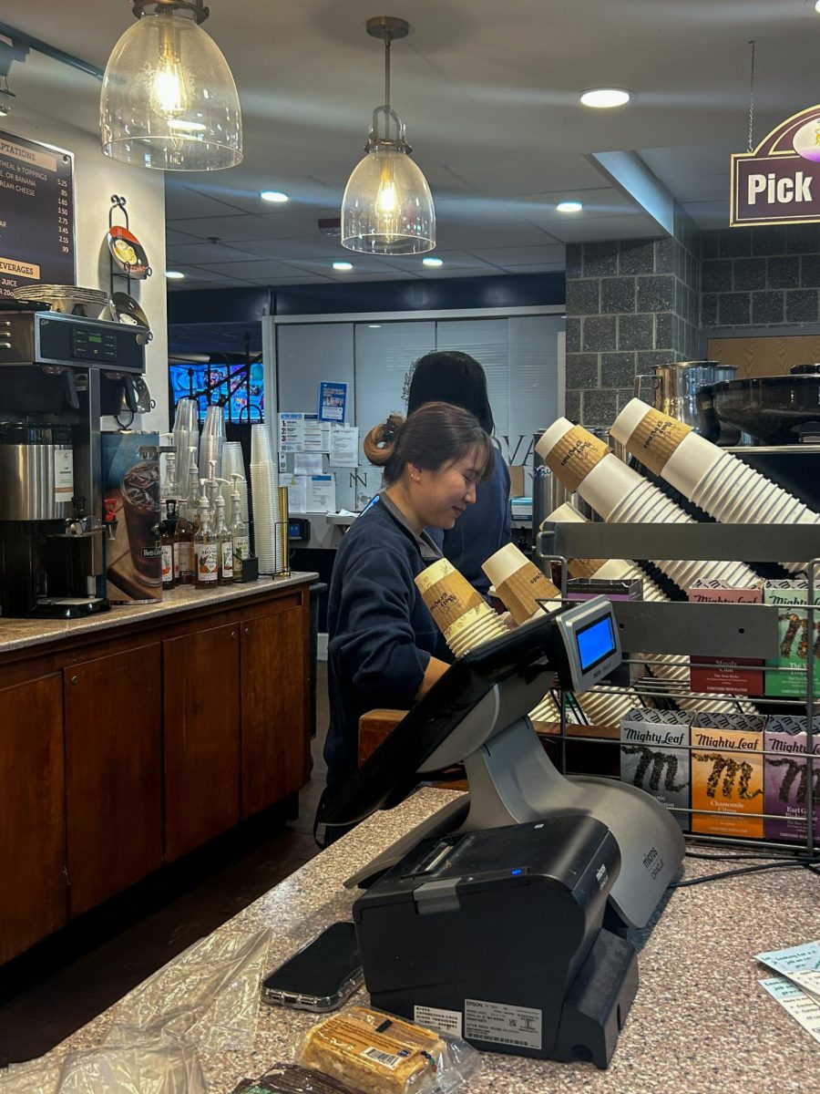 A Holy Grounds barista works in the Connelly Center in an on-campus job. 