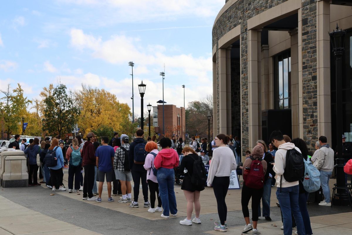 Students wait in line to vote for the first time.