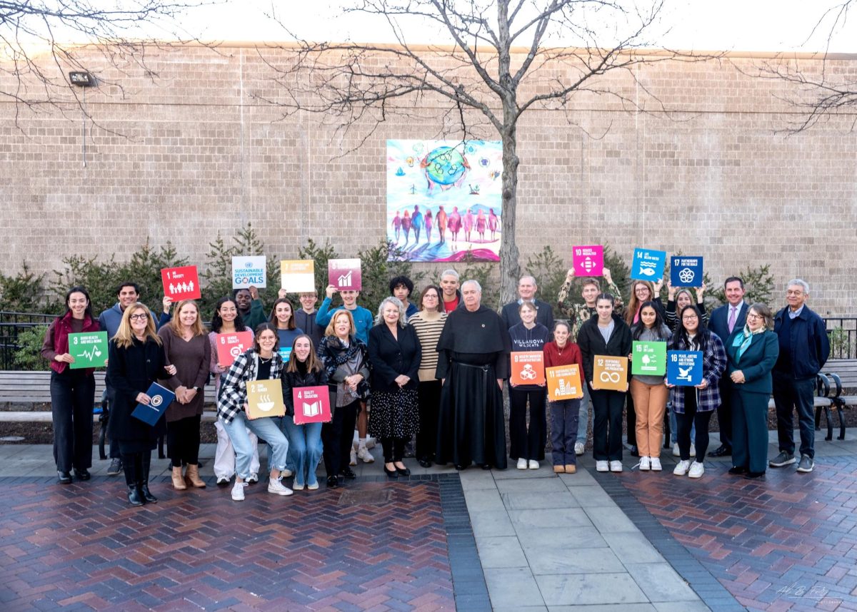 University faculty and students gather outside the new mural.