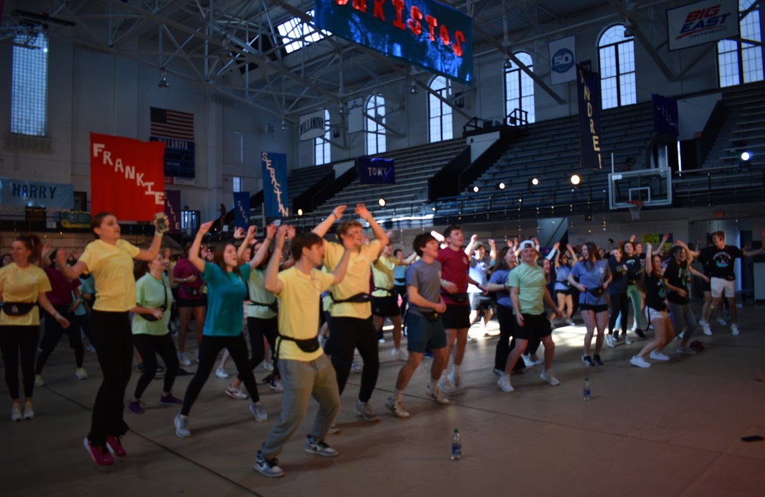 The iconic line dance ignites the entire room in joyful, slightly chaotic unison.  
