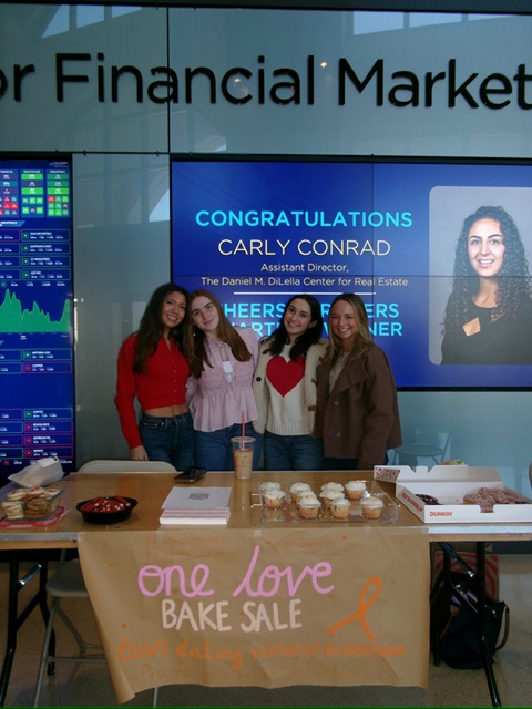 Organizers beam with pride in front of their bake sale.
